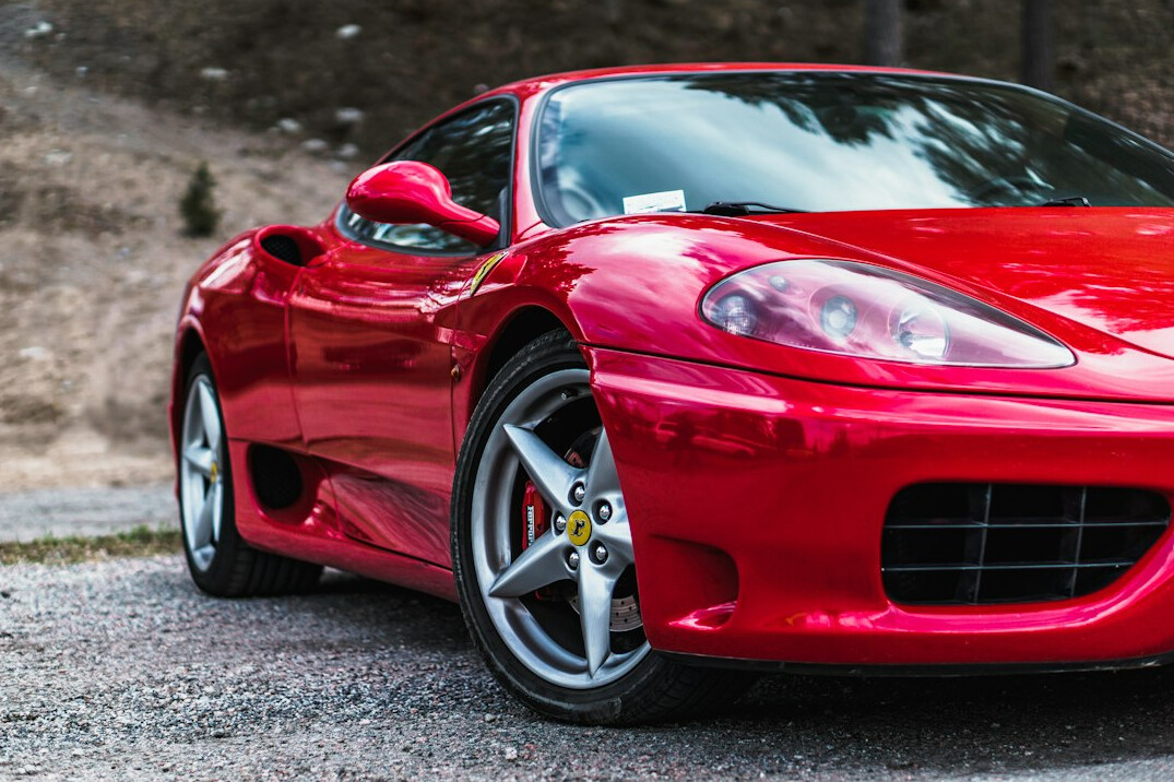 Red sports car with refinished wheels